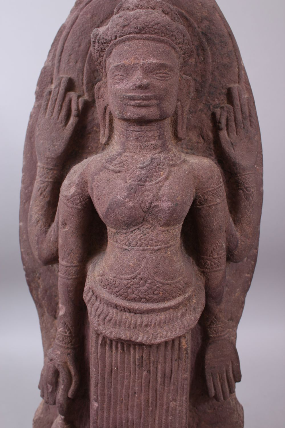 A 12TH CENTURY STYLE CAMBODIAN KHMER STYLE RED SANDSTONE CARVING OF A FOUR ARMED DEITY. 52cms high. - Image 5 of 6