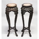 A PAIR OF 19TH CENTURY CHINESE CARVED HARDWOOD & MARBLE TOP PLANTERS / STANDS, both carved with