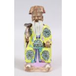 A 18TH CENTURY CHINESE FAMILLE ROSE PORCELAIN FIGURE OF AN IMMORTAL, wearing traditional attire,