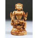 A 17TH/18TH CENTURY SOUTH INDIAN CARVED IVORY FIGURE OF A GODESS, seated on a lotus pad, 11cm high.