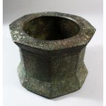 A VERY EARLY KHORASAN BRONZE OCTAGONAL SHAPED MORTAR, with ring handles, 18cm wide.