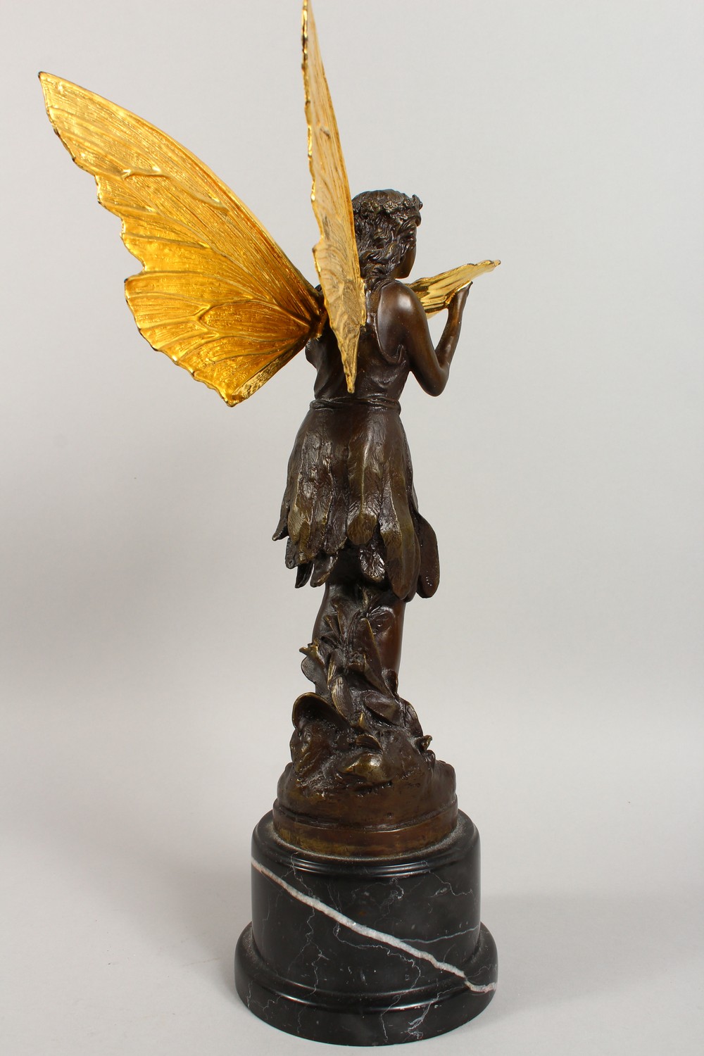 A BRONZE FIGURE OF A FAIRY, 20TH CENTURY, standing holding a shell in her hands, on a marble base. - Image 8 of 9