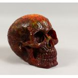 AN AMBER STYLE MODEL OF A SKULL. 7ins long.