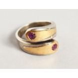 A STYLISH SILVER AND GOLD RING, set with two rubies.