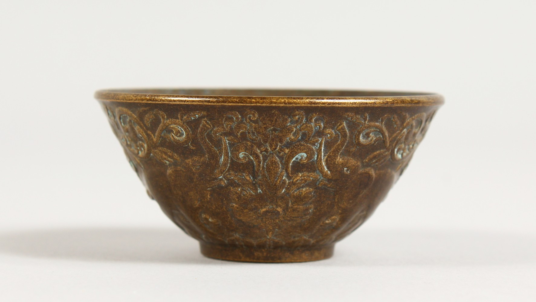 A SMALL BRONZE CUP. 2.5ins diameter.