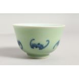 A CHINESE CELADON TEA BOWL, painted with bats. 3.5ins diameter.