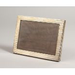 A RECTANGULAR ENGINE TURNED PHOTOGRAPH FRAME. Chester 1909. 7ins x 5.25ins.
