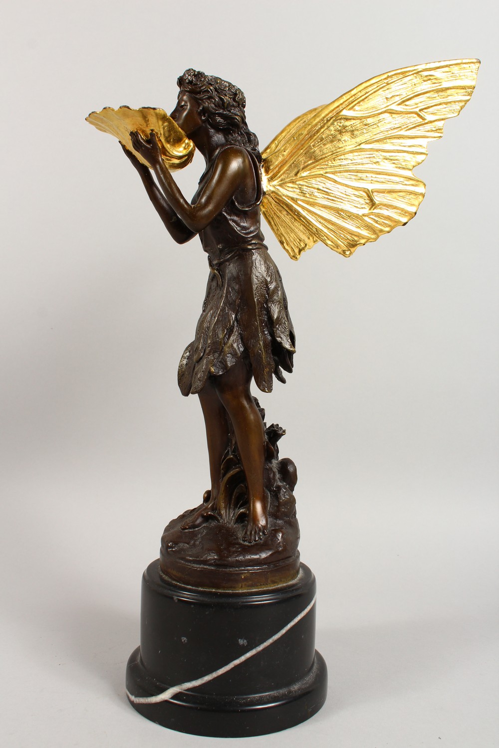 A BRONZE FIGURE OF A FAIRY, 20TH CENTURY, standing holding a shell in her hands, on a marble base. - Image 5 of 9