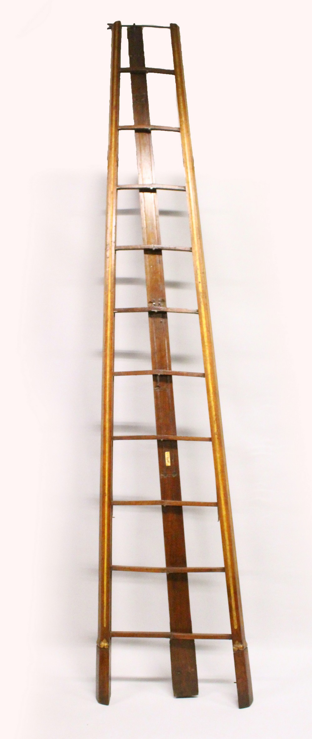 A VERY GOOD VICTORIAN GOTHIC REVIVAL MAHOGANY FOLDING LIBRARY LADDER, with fluted, parcel gilded