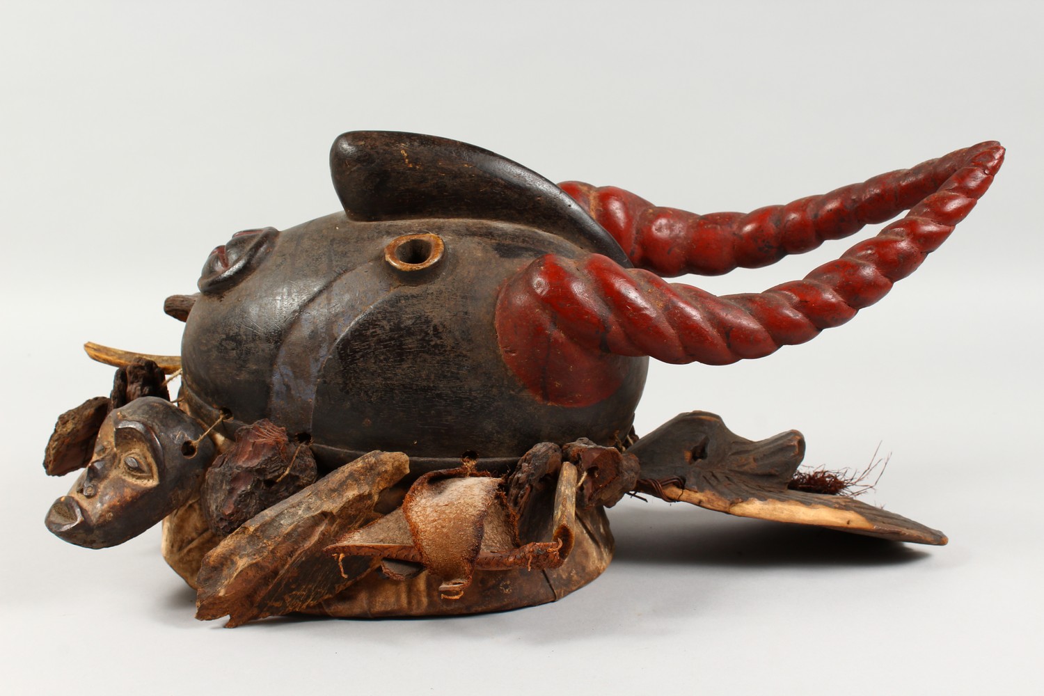 A GOOD CARVED AND PAINTED WOOD MASK, with red painted horns, and symbolic devices hung around the - Image 5 of 6