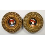 A PAIR OF EMBOSSED CIRCULAR BRASS PLAQUES, inset with porcelain panel decorated with portrait busts.