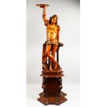 A VERY WELL CARVED 19TH CENTURY WOOD YOUNG CLASSICAL FIGURE, standing and holding a circular dish,