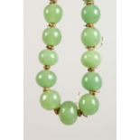 A JADE BEAD NECKLACE, with gold coloured clasp. 16ins long.