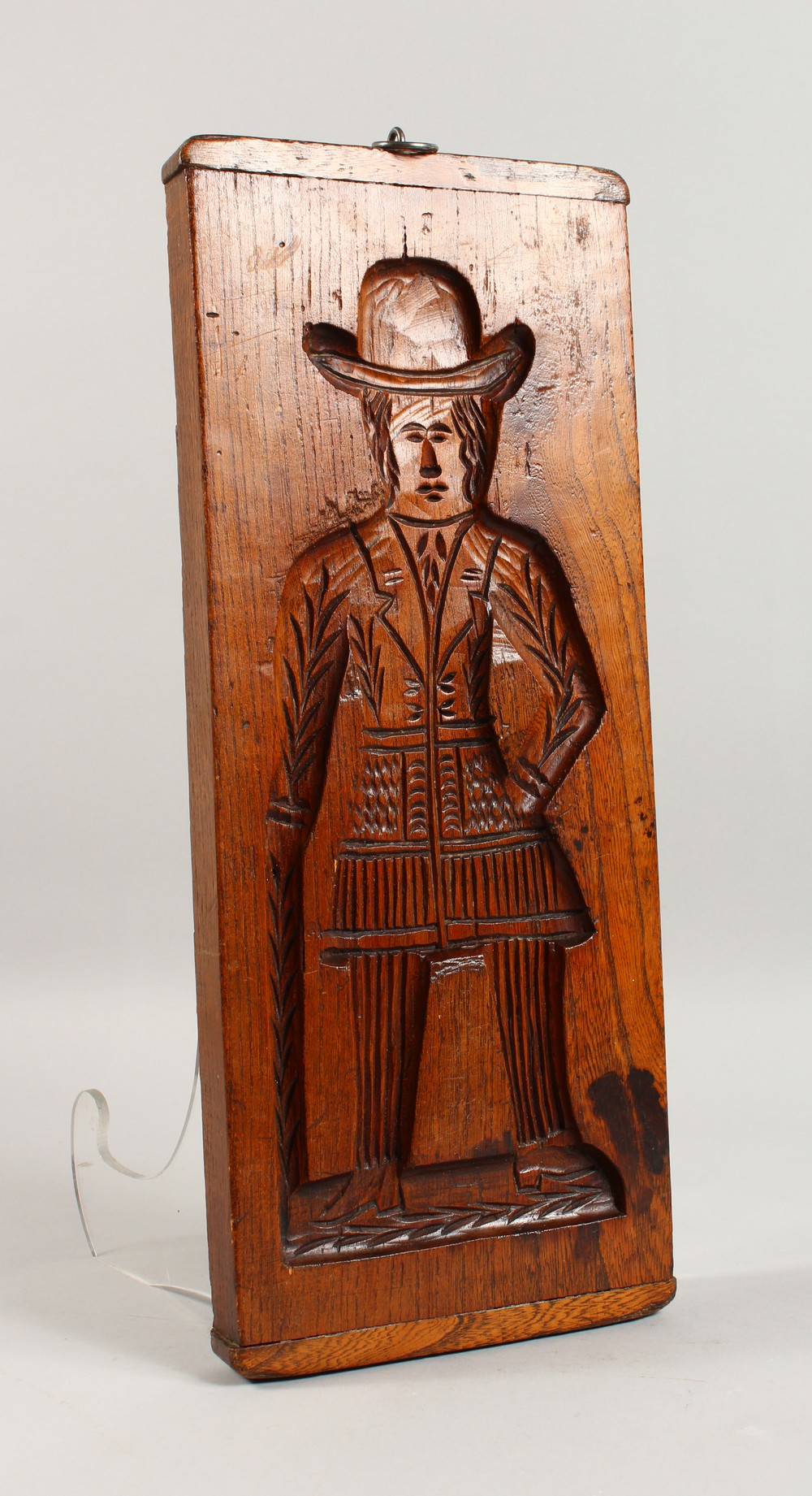 A 19TH CENTURY DOUBLE SIDED ELM GINGERBREAD MOULD, carved with a man and a woman. 18.5ins x 7.5ins.