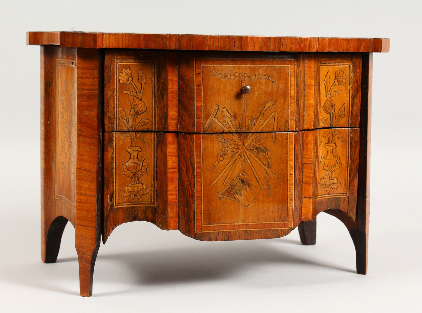 A GOOD CONTINENTAL MINIATURE TWO DRAWER MARQUETRY COMMODE, probably an apprentice piece, the top