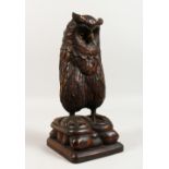 A GOOD LARGE BLACK FOREST CARVED OWL with glass eyes. 12.5ins high.