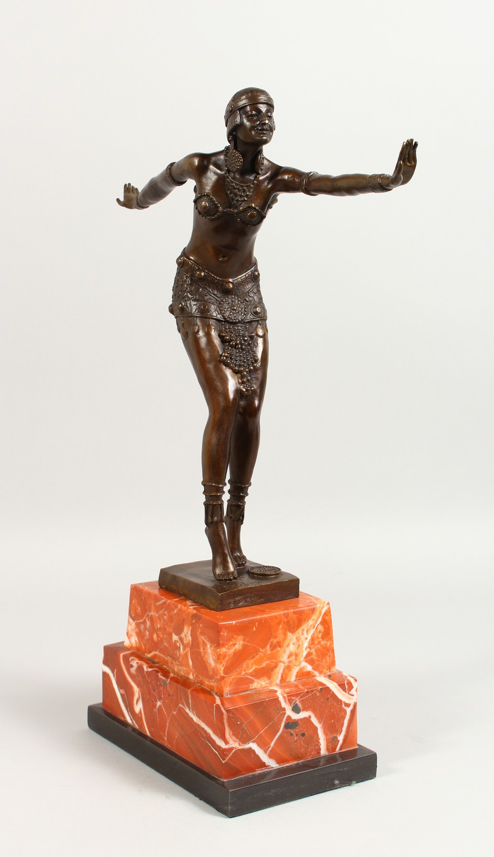 AN ART DECO STYLE BRONZE OF DANCERS, on a stepped marble base. 19ins high.