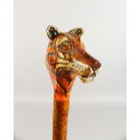 A WALKING STICK, the handle carved as a tiger. 52ins long.