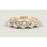 AN 18CT GOLD AND PLATINUM MOUNTED FIVE STONE DIAMOND RING of 1.2CTS.