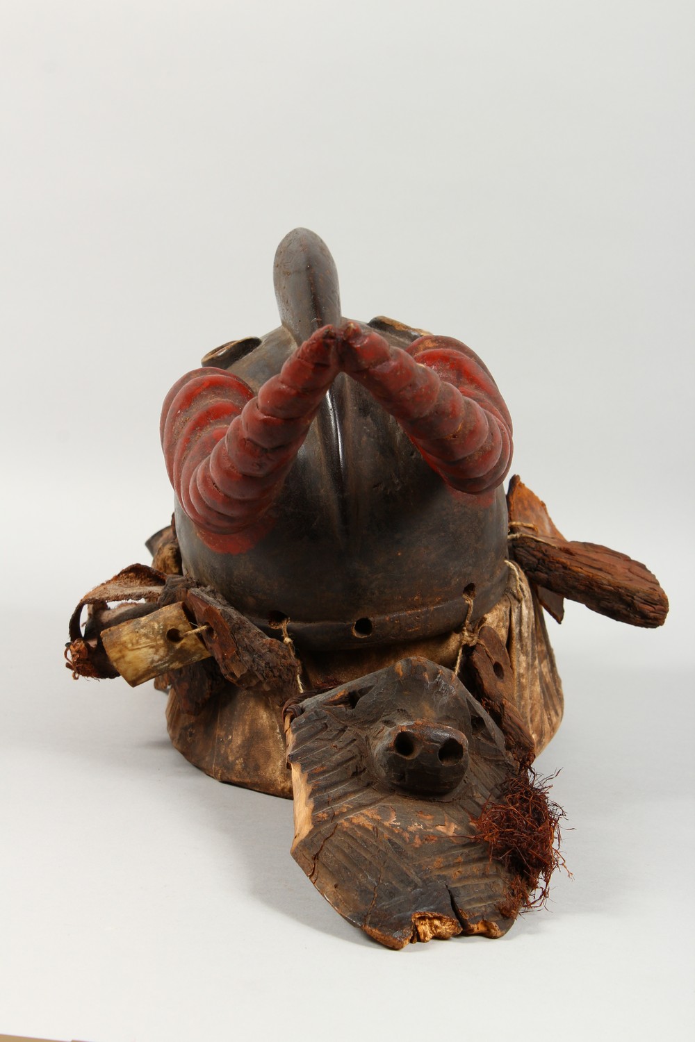A GOOD CARVED AND PAINTED WOOD MASK, with red painted horns, and symbolic devices hung around the - Image 2 of 6