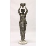 A 20TH CENTURY CAST SPELTER FIGURE OF A CLASSICAL LADY, holding aloft an urn, on a circular base (