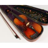 A MAHOGANY CASED VIOLIN, with bows. Violin back 14.5ins including button.