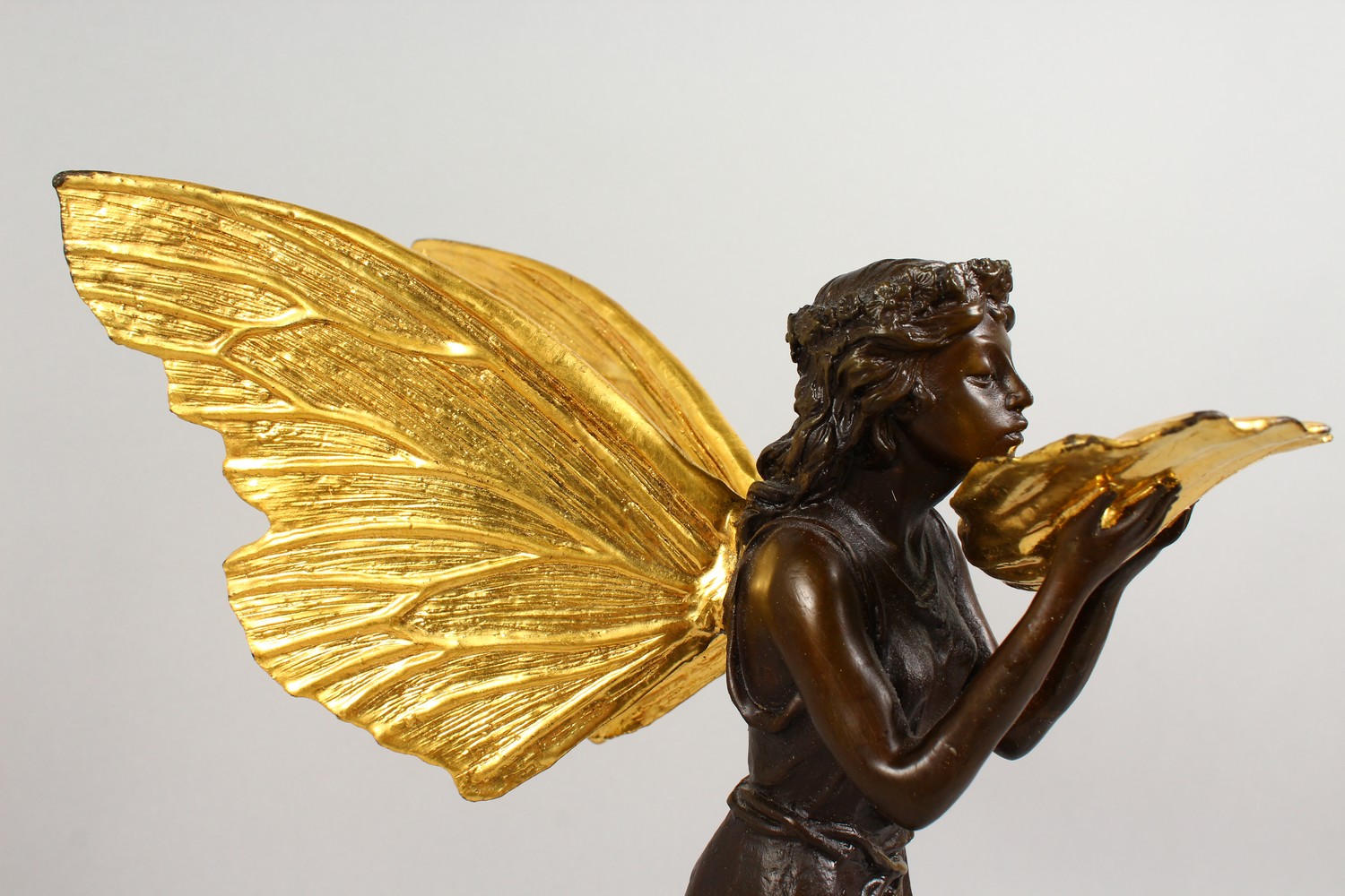 A BRONZE FIGURE OF A FAIRY, 20TH CENTURY, standing holding a shell in her hands, on a marble base. - Image 3 of 9