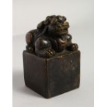 A BRONZE SQUARE SHAPE FO DOG SEAL. 4ins high.