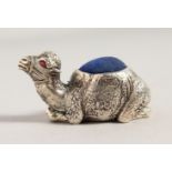 A CAST SILVER PLATE CAMEL PIN CUSHION. 2ins long.