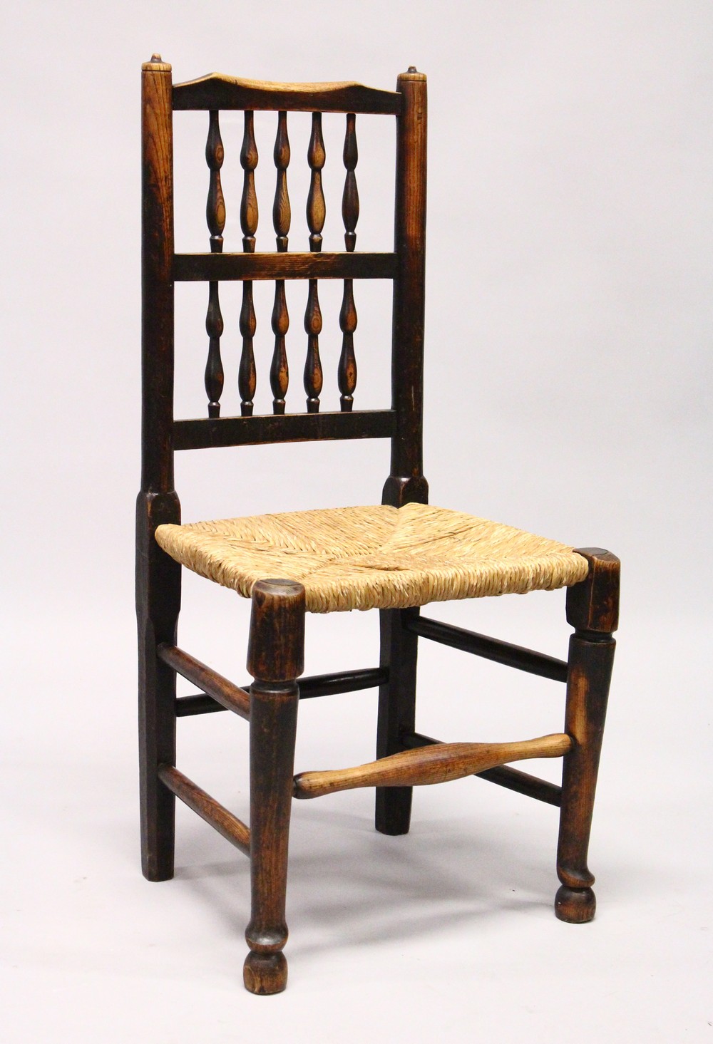 A MATCHED SET OF SIX 19TH CENTURY ASH SPINDLE BACK DINING CHAIRS, with rush seats on turned and