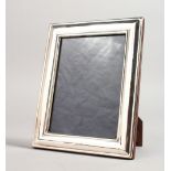 A PLAIN UPRIGHT PHOTOGRAPH FRAME. 7ins x 5.5ins.