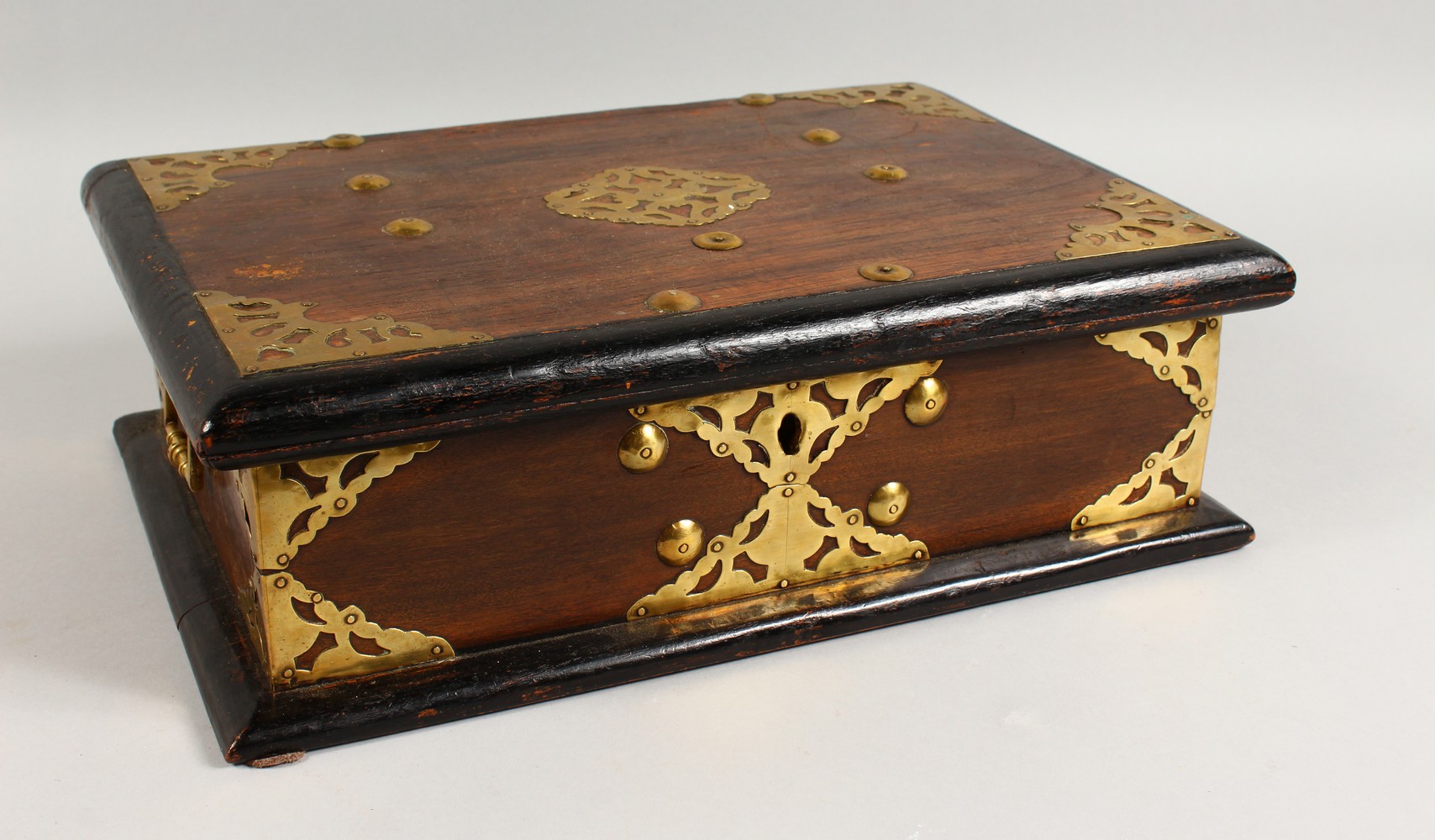 A 19TH CENTURY BRASS BOUND BOX, with brass carrying handles. 16.5ins wide.