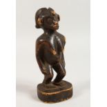 AN AFRICAN CARVED WOOD FIGURE OF A WOMAN. 6.5ins high.
