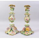 A PAIR OF COALBROOKDALE FLOWER ENCRUSTED CANDLESTICKS. 9.5ins high.