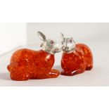 A PAIR OF AMBER RABBITS.