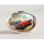 A SILVER OVAL PILL BOX, with enamel lid depicting a racing car.