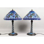 A PAIR OF TIFFANY STYLE TABLE LAMPS, with blue glass shades. 22ins high.