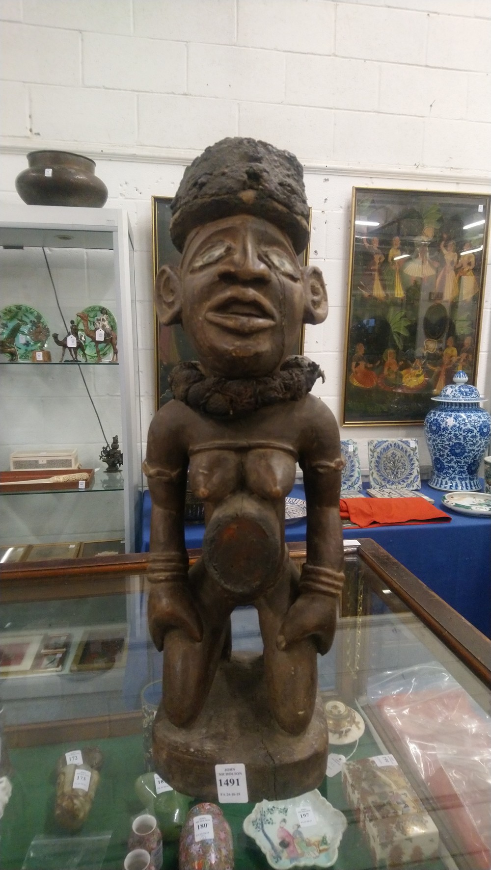 A CARVED WOOD AFRICAN FIGURE, a kneeling female nude wearing a large collar. 20ins high. - Image 9 of 9