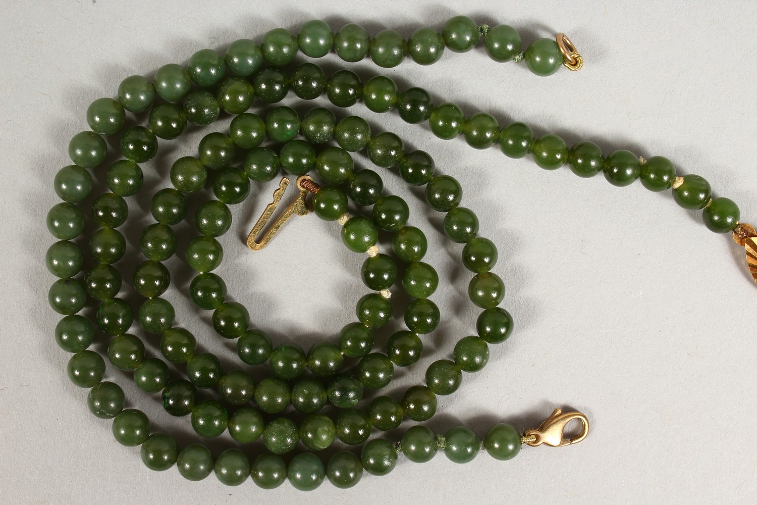 A JADE BEAD NECKLACE, with 9ct gold clasp; together with a similar bracelet. Necklace: 17ins long. - Image 4 of 4