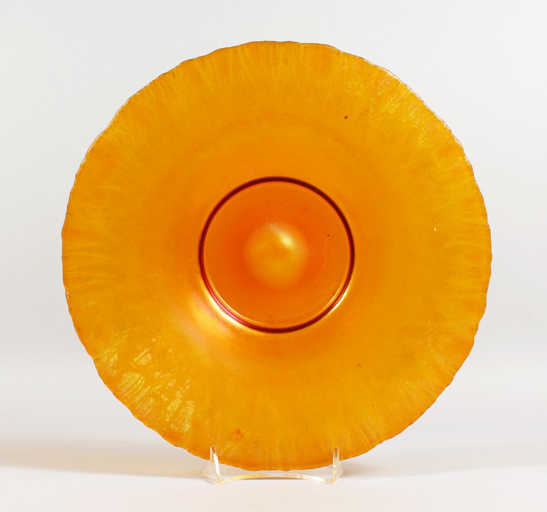 AN ART NOUVEAU ORANGE LUSTRE CIRCULAR GLASS DISH. 12.25ins diameter.