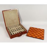 A GOOD LEATHER CASED CHESS SET. 13ins wide.
