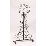 A GOOD 17TH CENTURY WROUGHT IRON FLOOR STANDING CANDELABRA, with a revolving top, ornate support