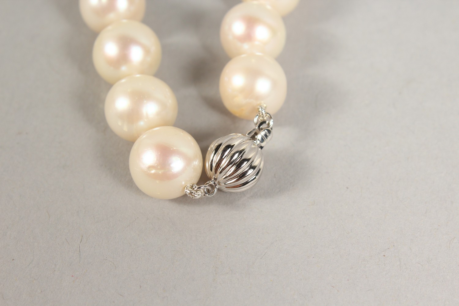 A PEARL NECKLACE, with three diamond and enamel sections and 18ct gold clasp. 18ins long. - Image 4 of 5