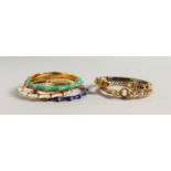 SIX ENAMEL DECORATED GILT METAL BANGLES. 3ins diameter.