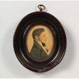 AN OVAL PORTRAIT MINIATURE OF A GENTLEMAN, in an ebony frame. 4.5ins x 4ins.