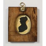AN OVAL SILHOUETTE OF A LADY, in a wooden frame. 5.25ins x 4.25ins.