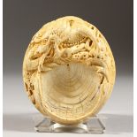 A GOOD CHINESE CARVED IVORY BRUSH HOLDER, carved with dragons. 3ins x 2.5ins.