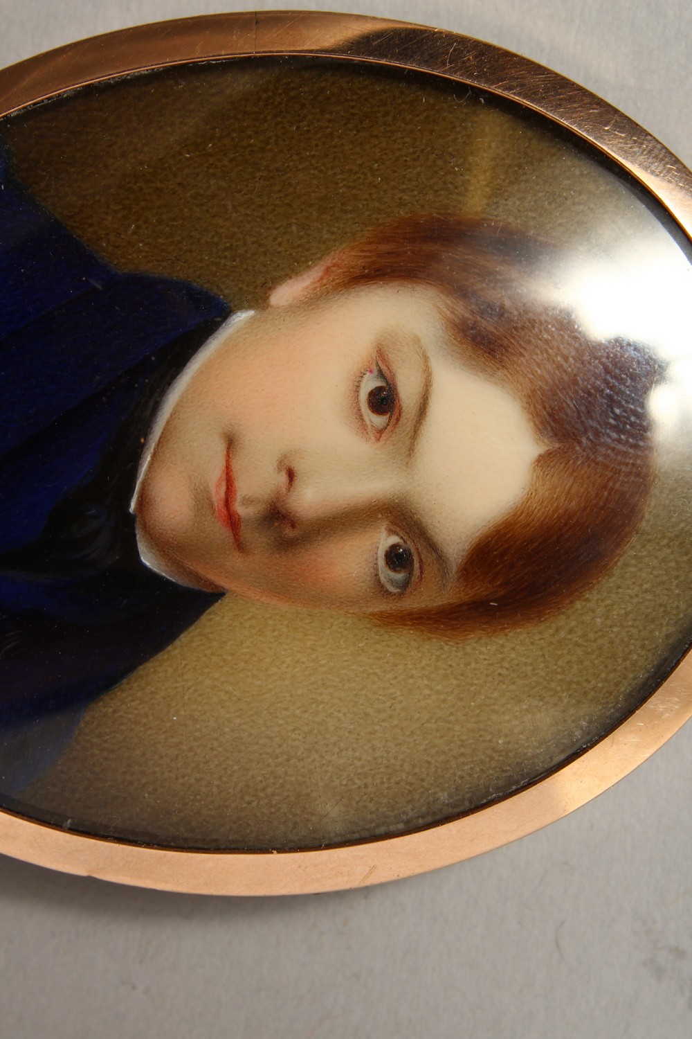 AN EARLY 19TH CENTURY PORTRAIT MINIATURE of a young boy in a blue coat, plaited hair to reverse. 2. - Image 2 of 3