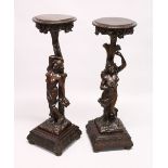 A GOOD PAIR OF CONTINENTAL WALNUT CARVED STANDS, EARLY 20TH CENTURY, with circular tops, carved