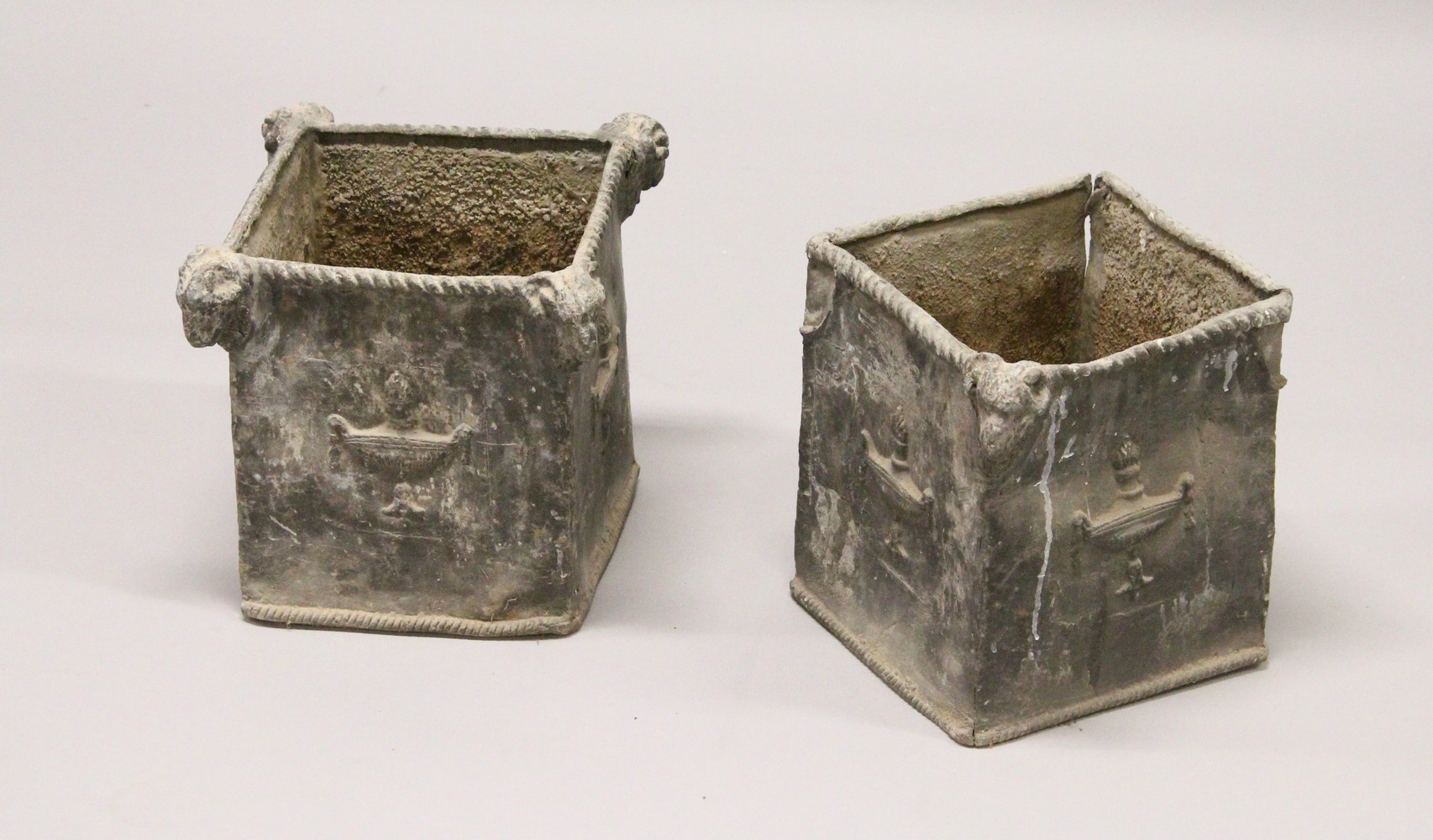 A PAIR OF 19TH/20TH CENTURY LEAD PLANTERS, of square shape, with rams head corners and classical